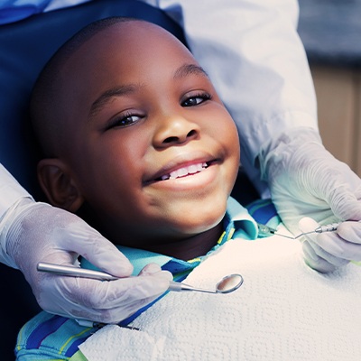 Child smiling during dental checkup and teeth cleaning visit