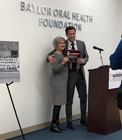 Dentist receiving award from the Baylor Oral Health Foundation