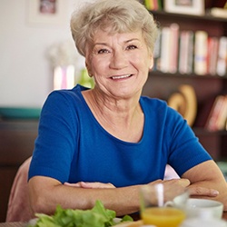Senior woman sitting at table for a meal