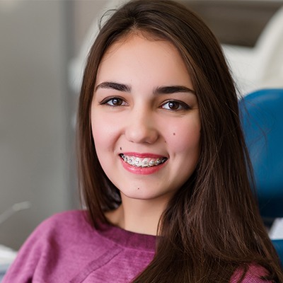 Closeup of smile during traditional orthodontics treatment