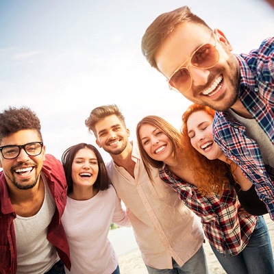 Group of friends smiling outside together