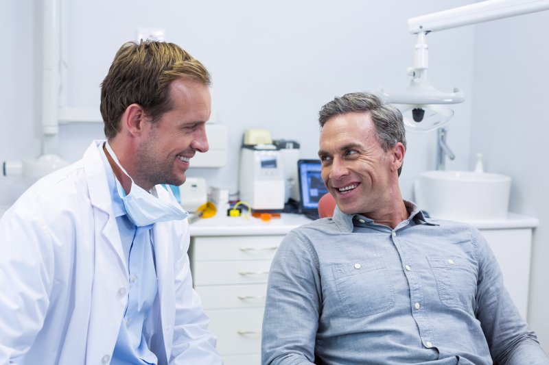 dentist speaking to patient about color-matching dental crowns