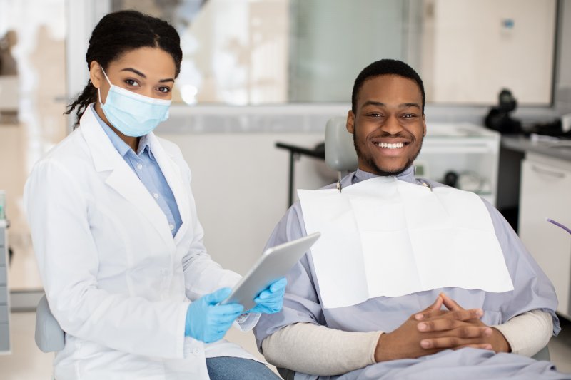 patient smiling while visiting dentist 