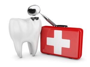 Injured tooth next to red emergency kit